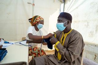 Community worker measuring blood pressure in Senegal